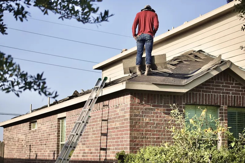 Professional roofer working on a residential roof in Garrettford